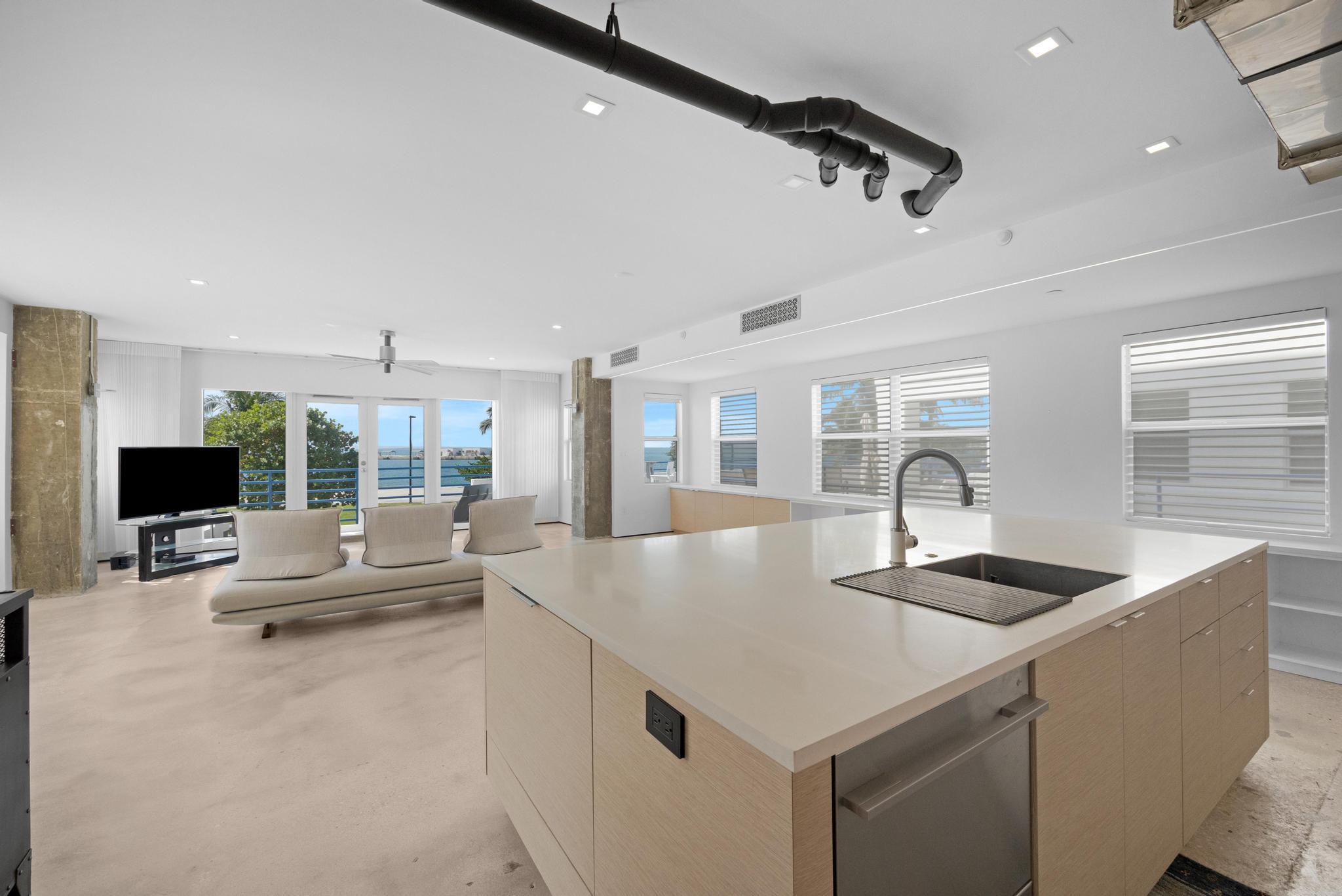 105 Front Street, Unit 122 Key West, FL 33040 - Photo 16 of 52 a kitchen with a counter space a sink appliances and a counter top space