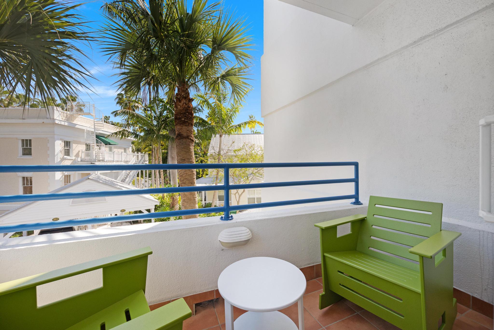 105 Front Street, Unit 122 Key West, FL 33040 - Photo 28 of 52 a room with a table chairs and a potted plant