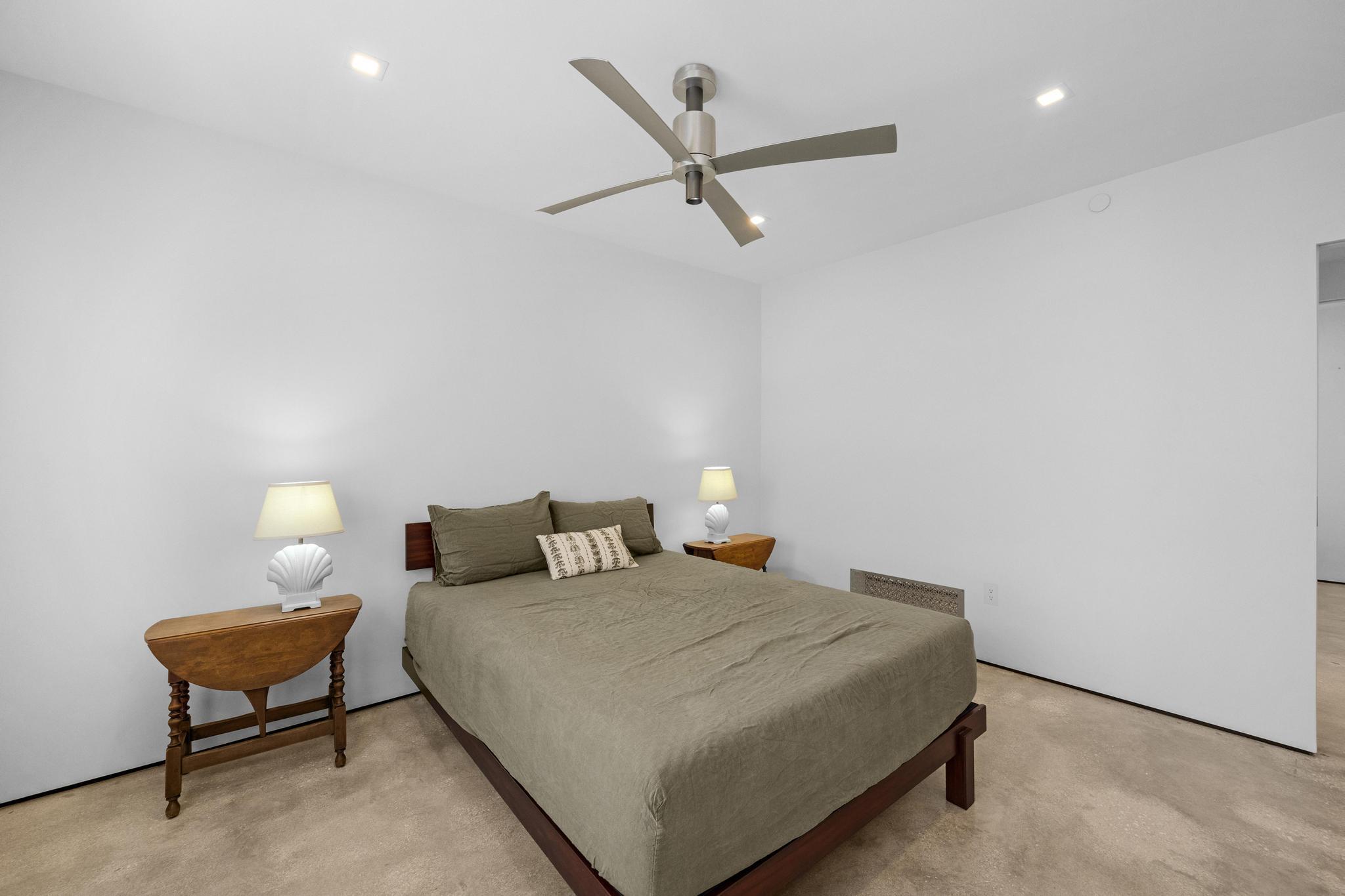 105 Front Street, Unit 122 Key West, FL 33040 - Photo 30 of 52 a bedroom with a bed and a chandelier