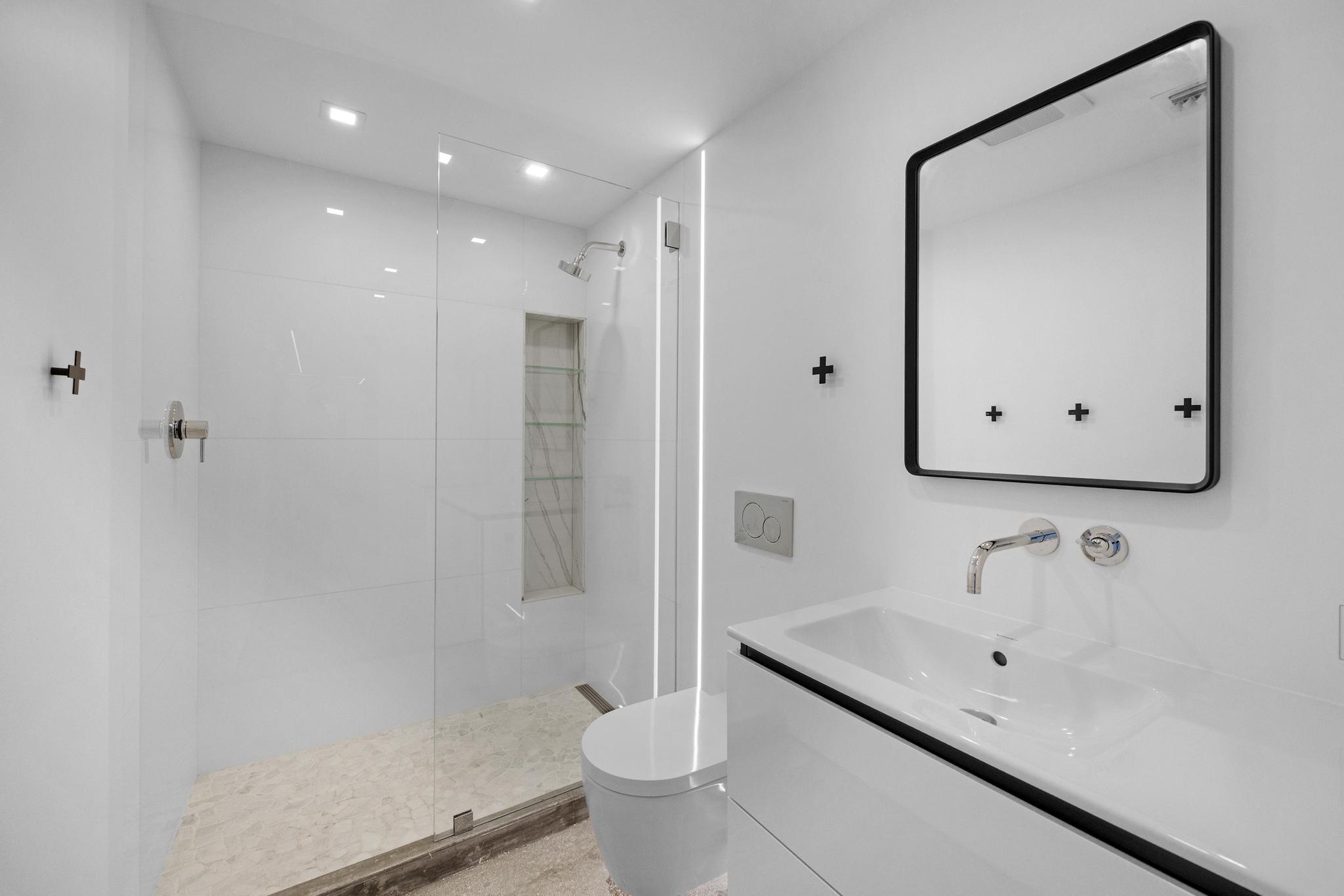 105 Front Street, Unit 122 Key West, FL 33040 - Photo 34 of 52 a bathroom with a sink toilet and shower