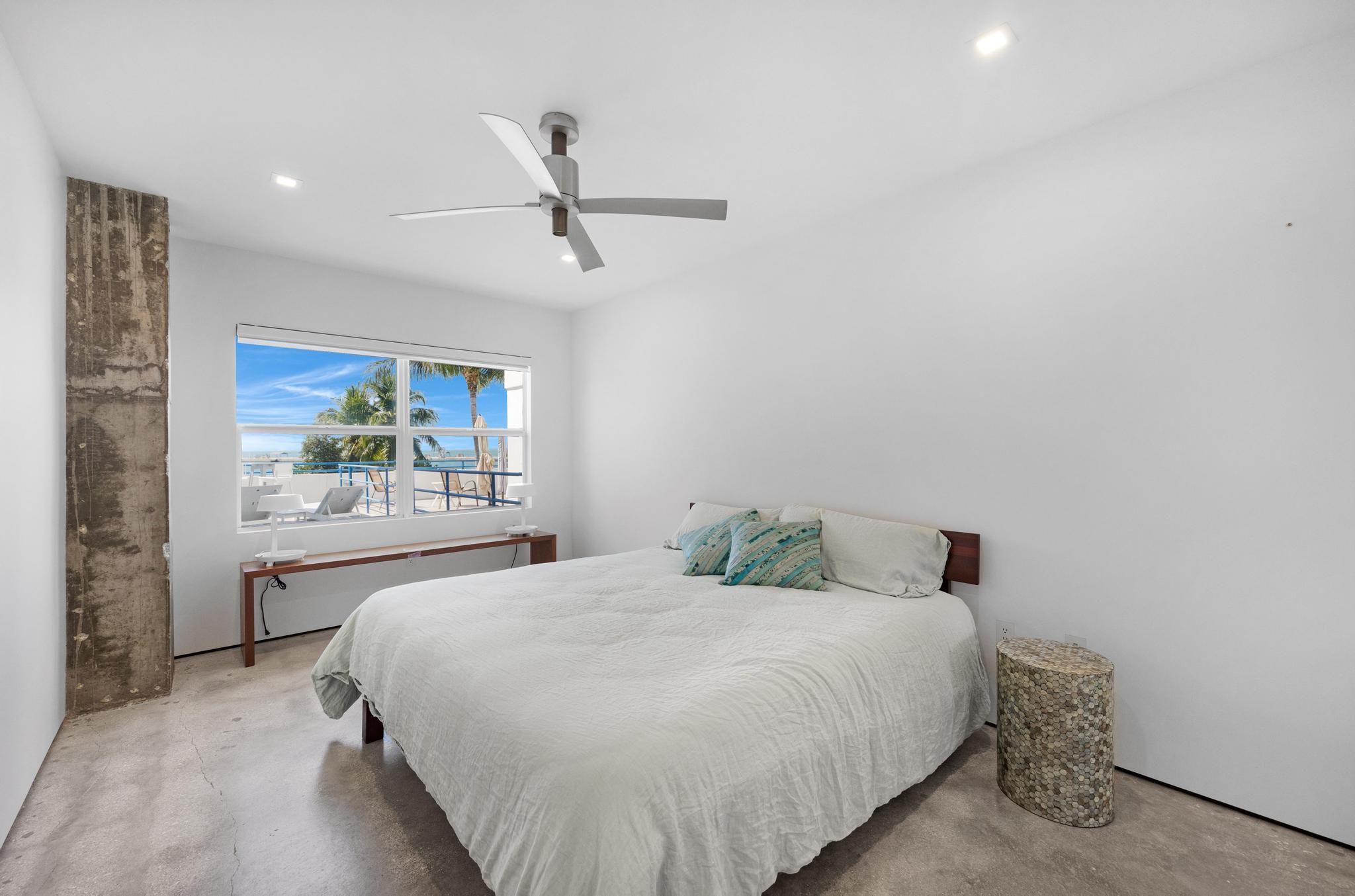 105 Front Street, Unit 122 Key West, FL 33040 - Photo 36 of 52 a bedroom with a large bed and a window