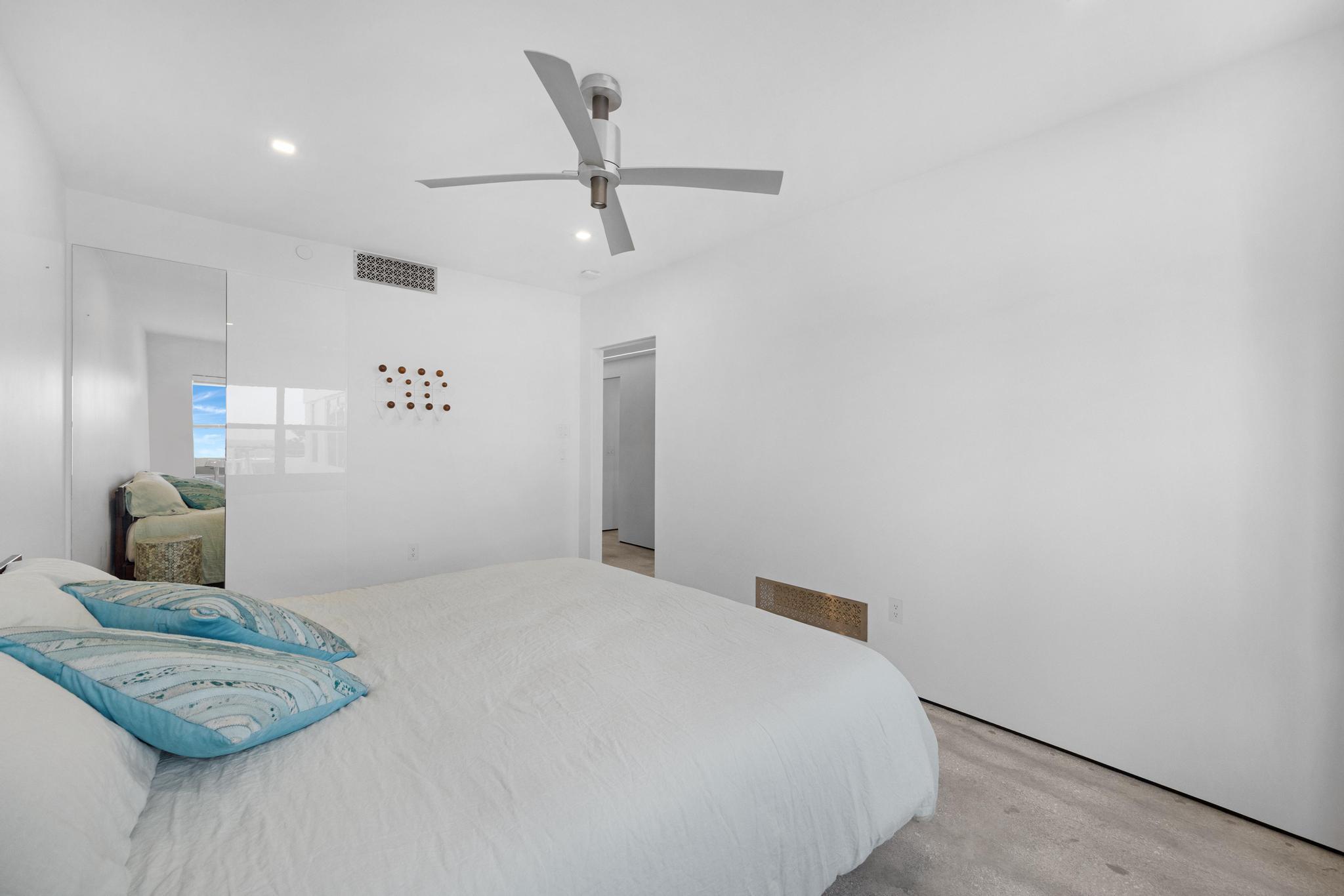 105 Front Street, Unit 122 Key West, FL 33040 - Photo 39 of 52 a bedroom with a large bed and a chandelier