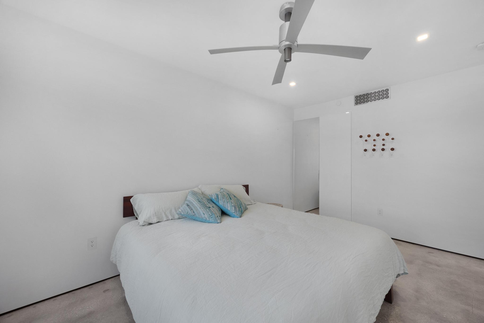 105 Front Street, Unit 122 Key West, FL 33040 - Photo 40 of 52 a bedroom with a bed and a ceiling fan