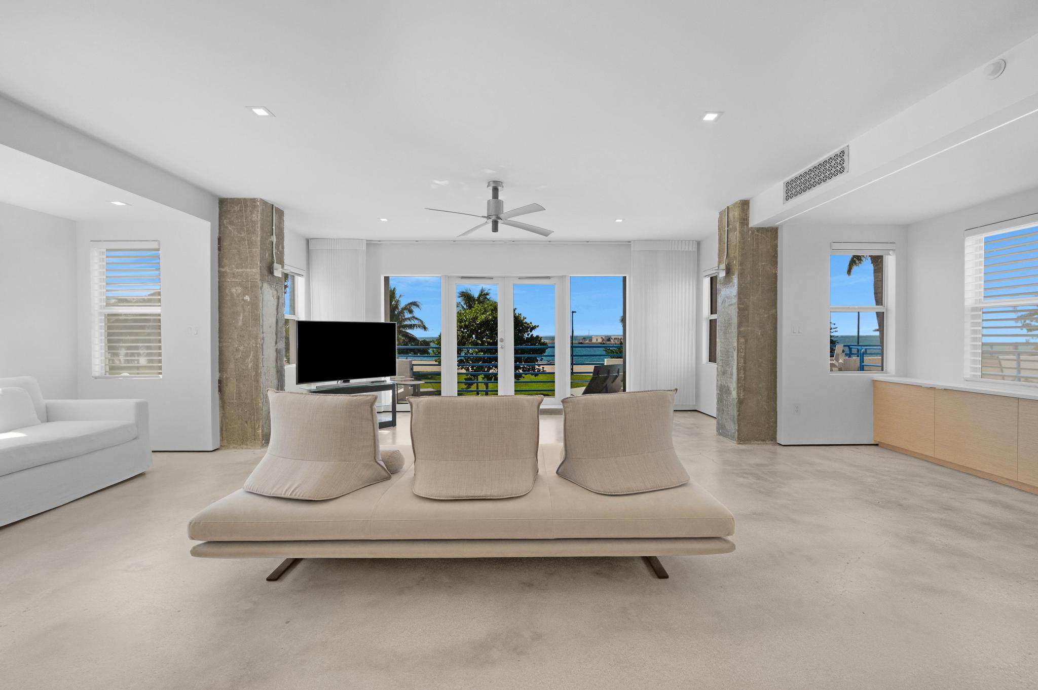 105 Front Street, Unit 122 Key West, FL 33040 - Photo 4 of 52 a living room with furniture a flat screen tv and a large window