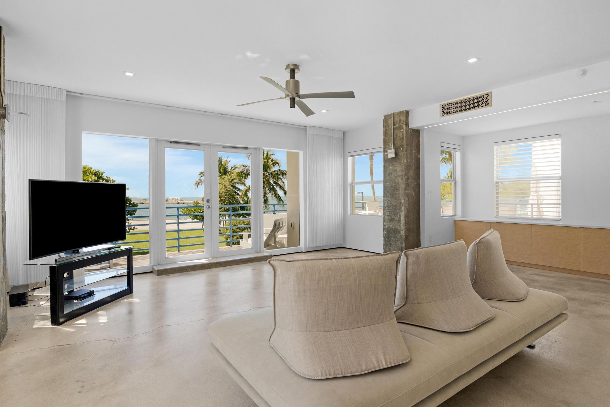 105 Front Street, Unit 122 Key West, FL 33040 - Photo 5 of 52 a living room with furniture and a flat screen tv