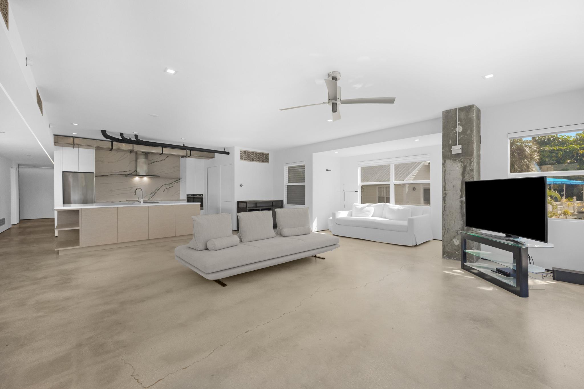 105 Front Street, Unit 122 Key West, FL 33040 - Photo 10 of 52 a living room with furniture and a flat screen tv