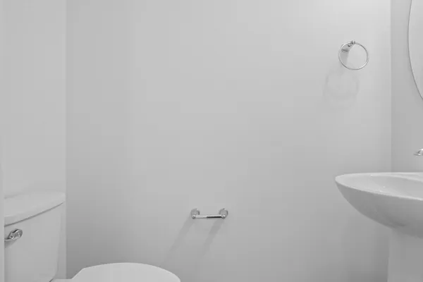 a white toilet sitting next to a white sink