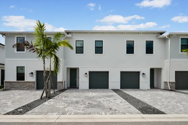 a view of a house with a yard and garage