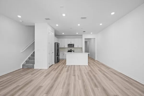 a view of kitchen living room with wooden floor and kitchen