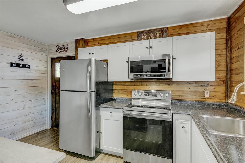 500 Two Coves Hemphill, TX 75948 - Photo 12 of 36 a kitchen with stainless steel appliances a refrigerator stove and microwave