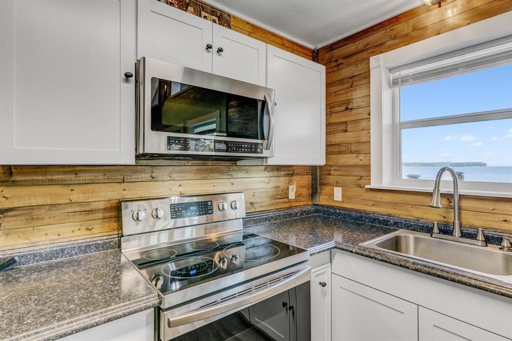 500 Two Coves Hemphill, TX 75948 - Photo 13 of 36 a kitchen with stainless steel appliances a sink and a microwave