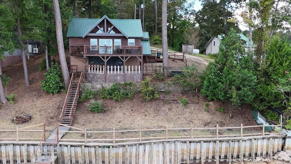 500 Two Coves Hemphill, TX 75948 - Photo 23 of 36 a view of a house with a small yard and wooden fence