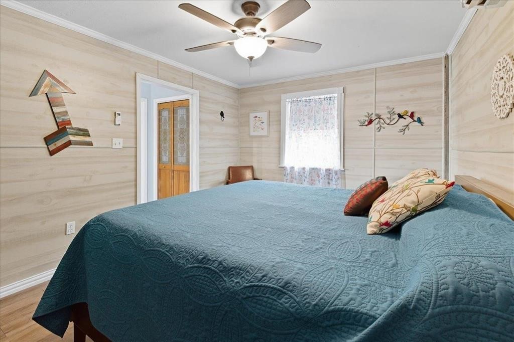 500 Two Coves Hemphill, TX 75948 - Photo 30 of 36 a bedroom with a bed and a chandelier