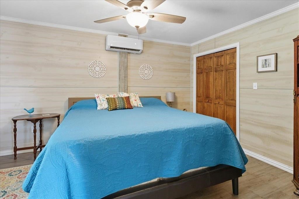 500 Two Coves Hemphill, TX 75948 - Photo 32 of 36 a bedroom with a bed and a chandelier
