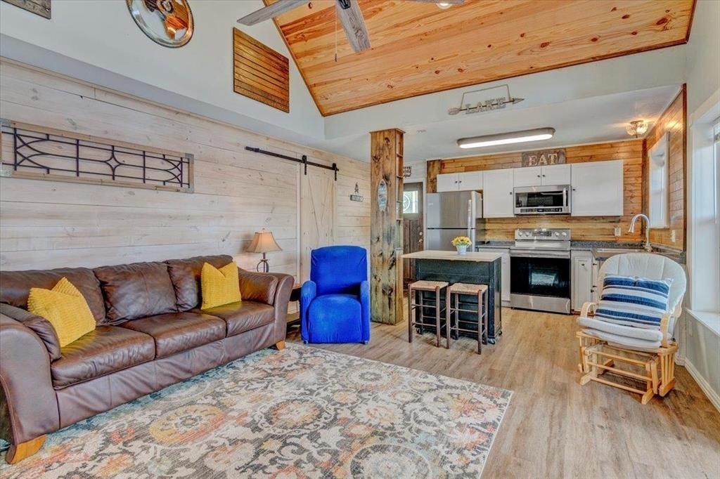 500 Two Coves Hemphill, TX 75948 - Photo 7 of 36 a living room with furniture a fireplace and kitchen view