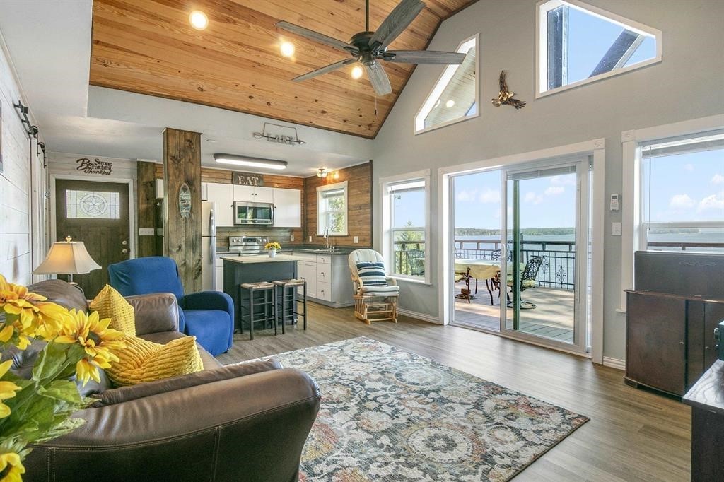 500 Two Coves Hemphill, TX 75948 - Photo 8 of 36 a living room with furniture floor to ceiling window and wooden floor