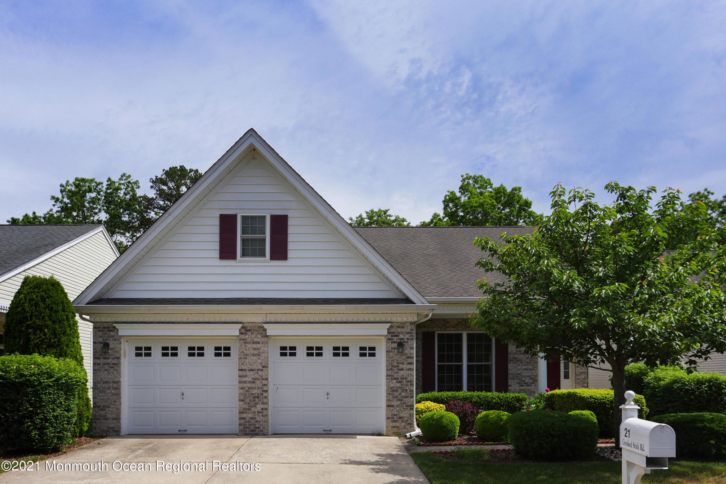 21 Crooked Stick Road Jackson, NJ 08527 - Photo 2 of 37 a front view of a house with a garden