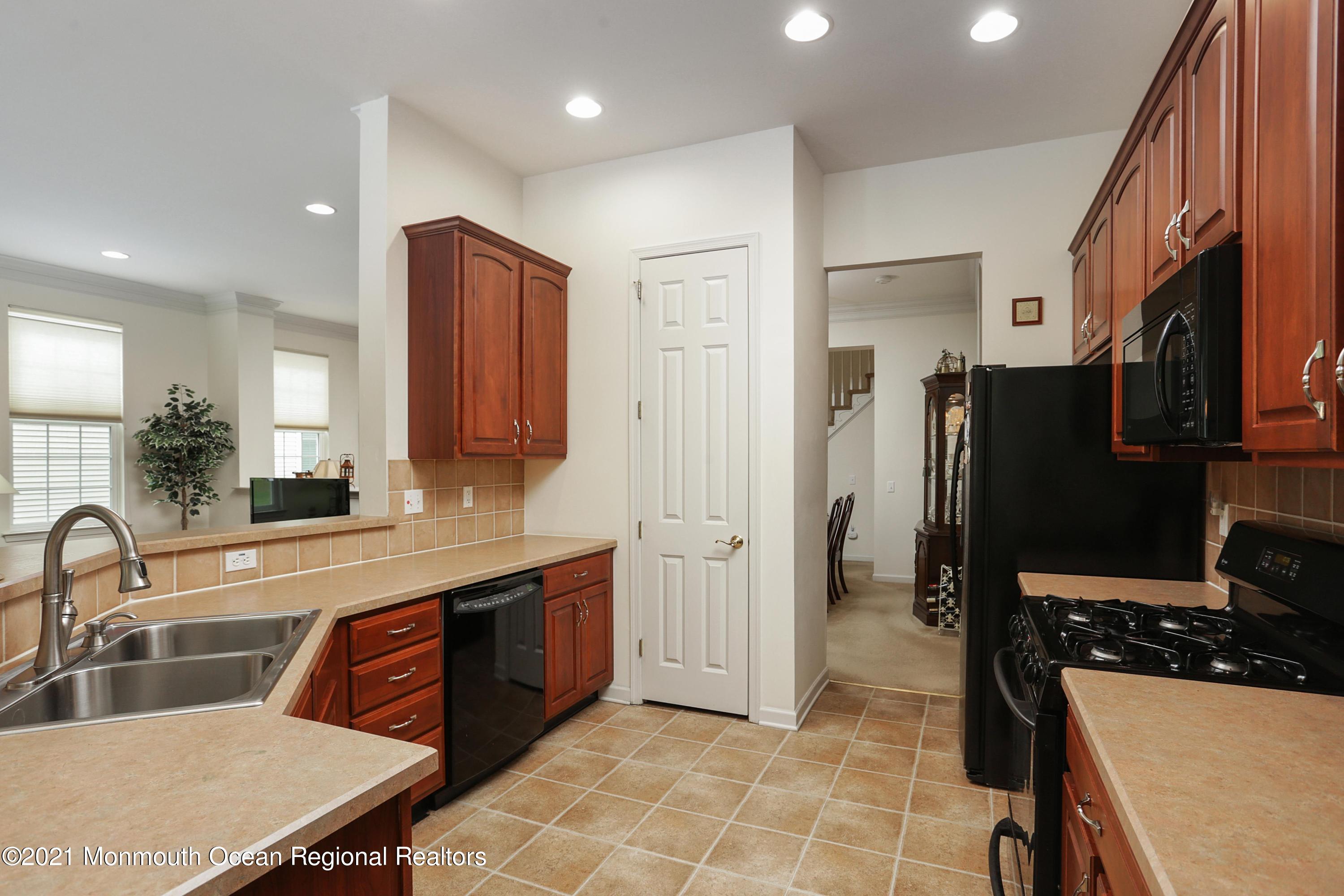 21 Crooked Stick Road Jackson, NJ 08527 - Photo 12 of 37 a kitchen with stainless steel appliances granite countertop a sink stove and refrigerator