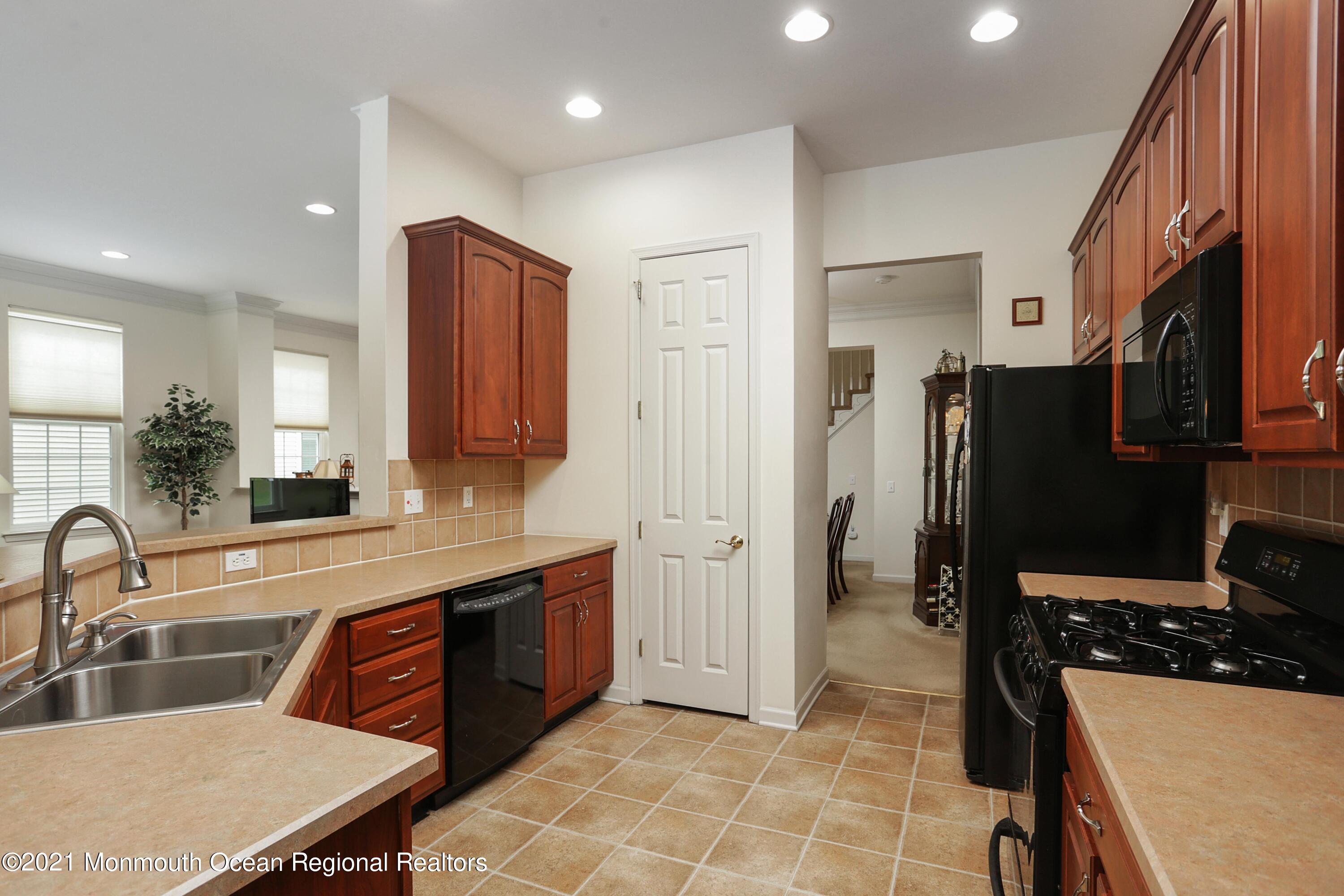 21 Crooked Stick Road Jackson, NJ 08527 - Photo 13 of 37 a kitchen with stainless steel appliances granite countertop a sink stove and refrigerator