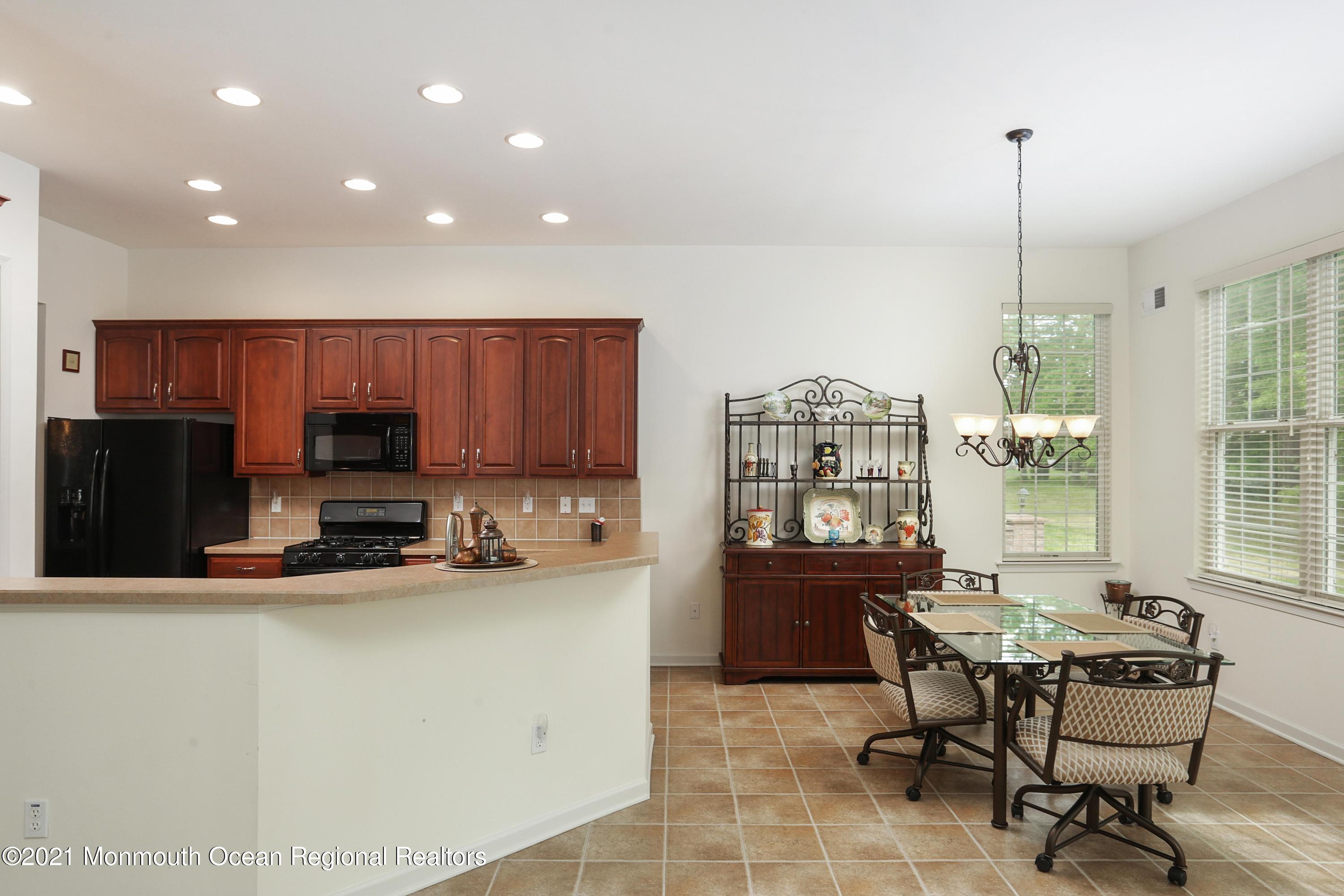 21 Crooked Stick Road Jackson, NJ 08527 - Photo 14 of 37 a kitchen with kitchen island granite countertop a sink and a stove