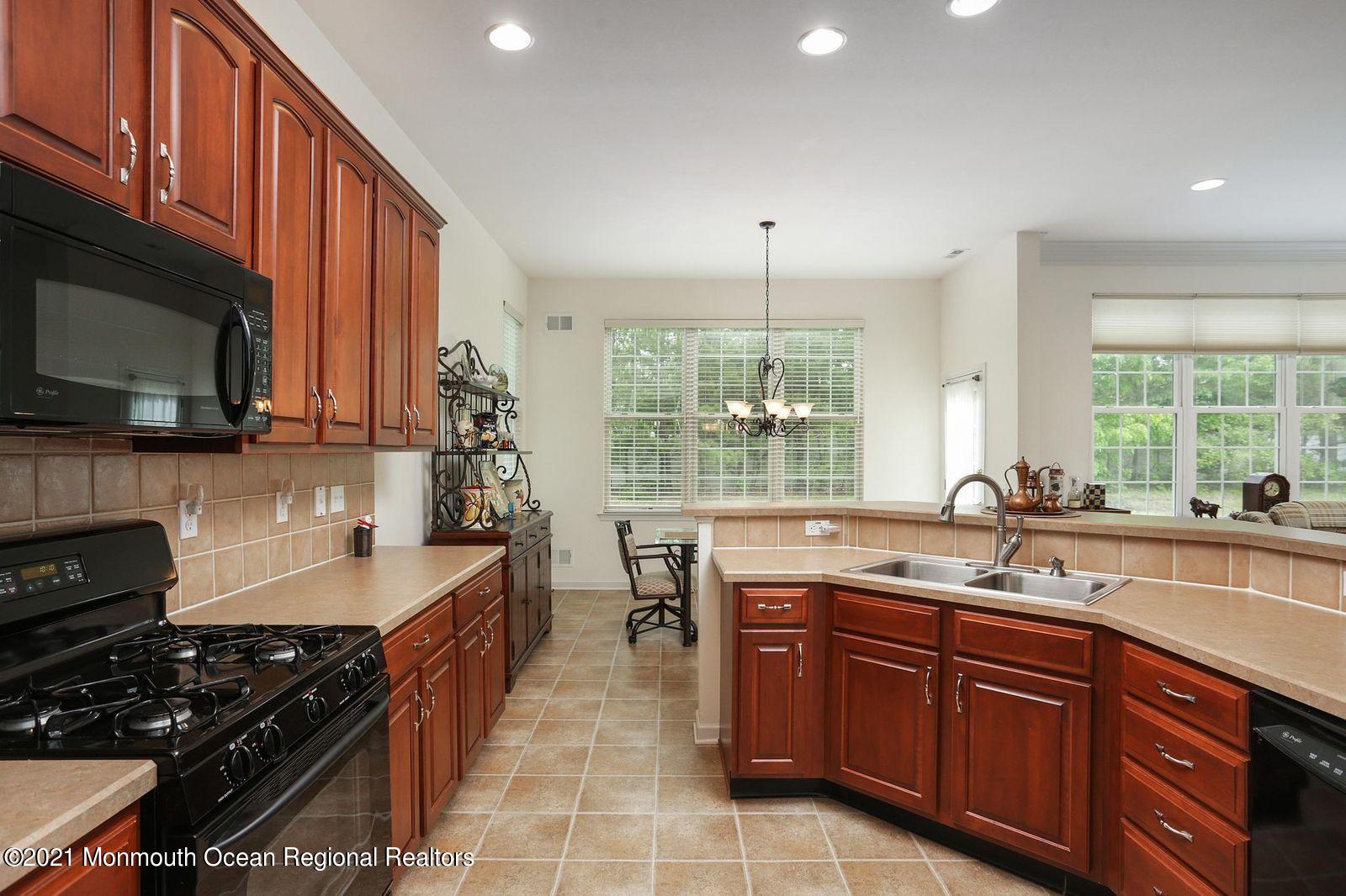 21 Crooked Stick Road Jackson, NJ 08527 - Photo 15 of 37 a kitchen with a sink stove and microwave