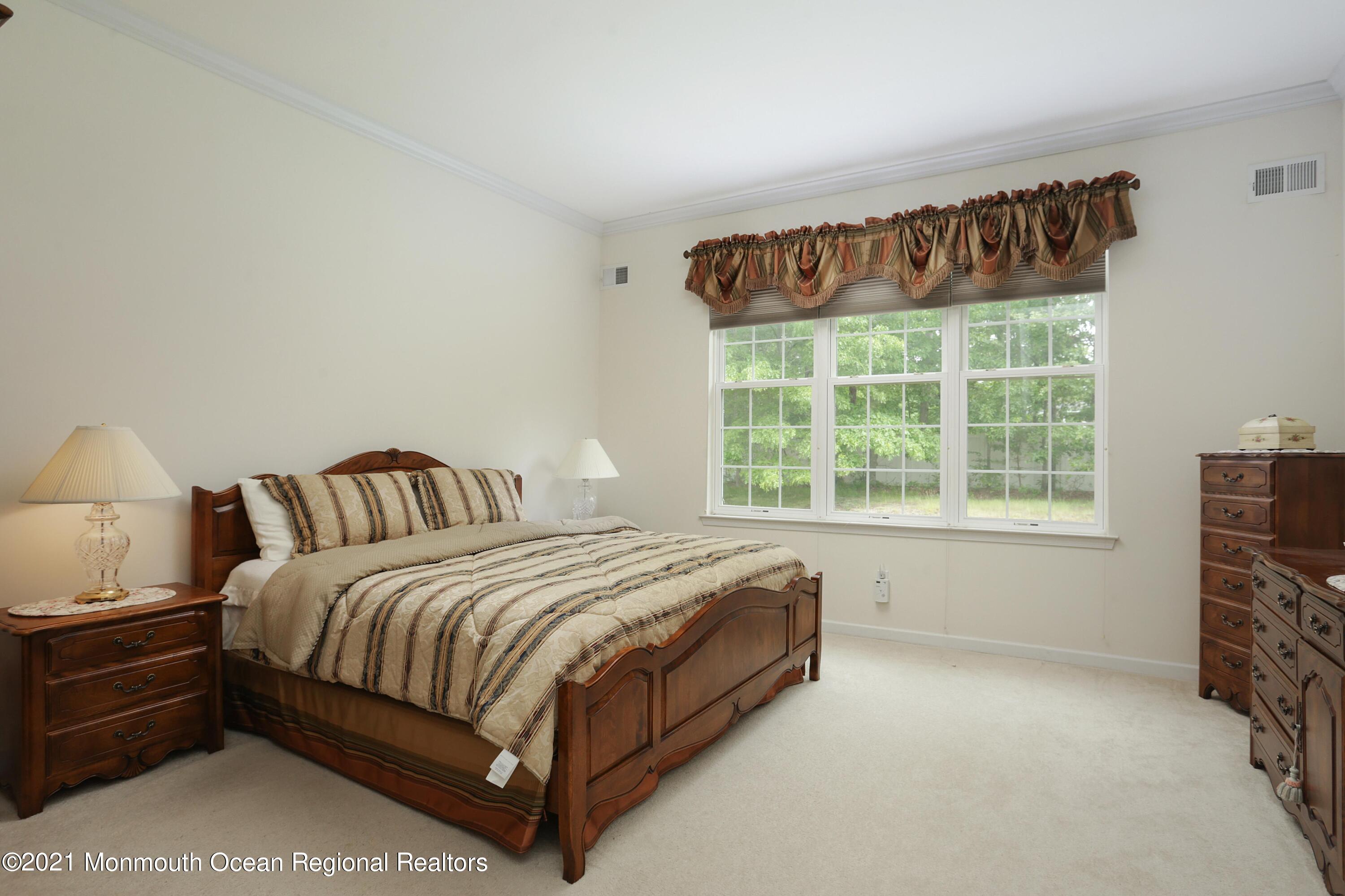 21 Crooked Stick Road Jackson, NJ 08527 - Photo 17 of 37 a spacious bedroom with a bed and a window