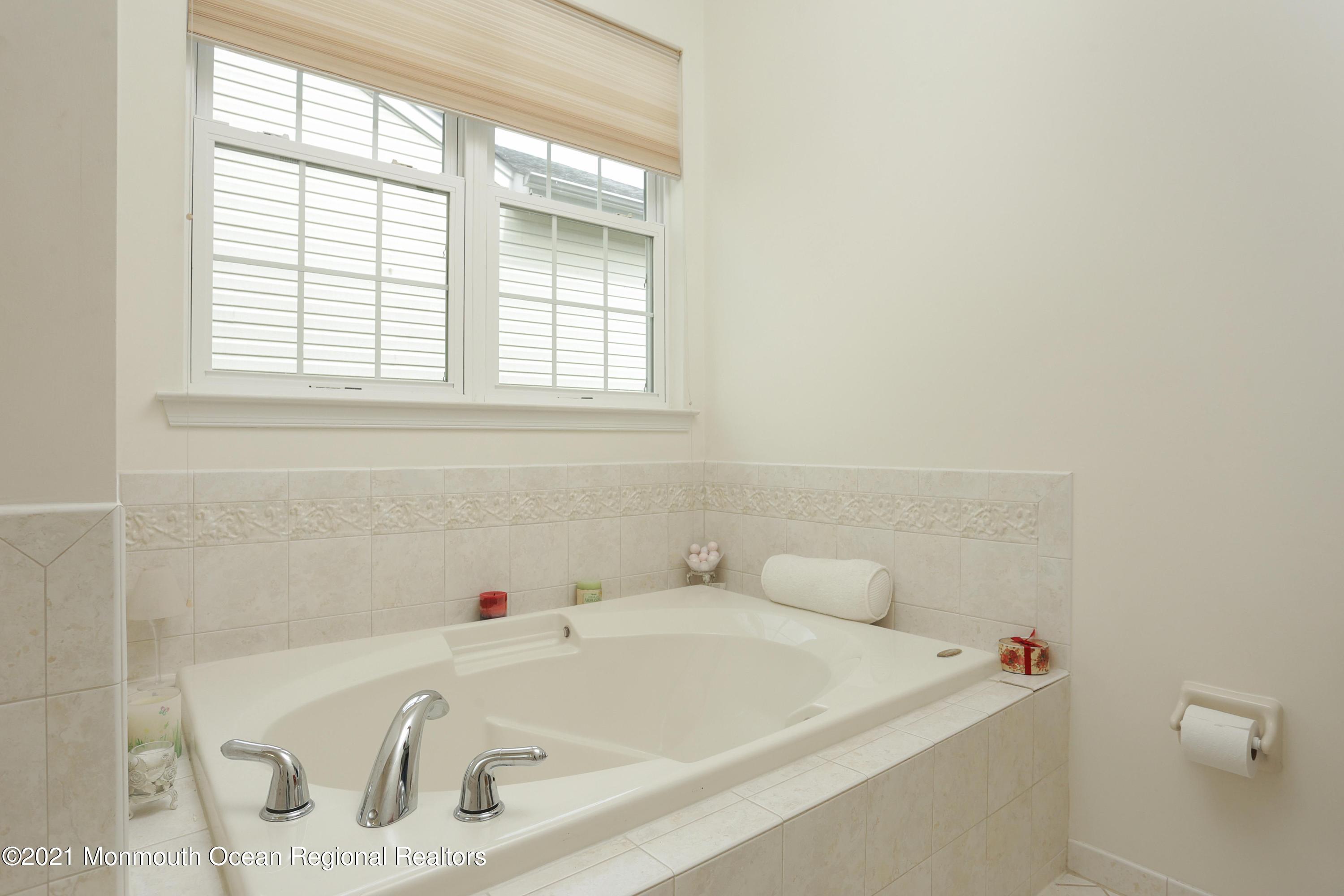 21 Crooked Stick Road Jackson, NJ 08527 - Photo 19 of 37 a white bath tub sitting in a bathroom next to a window