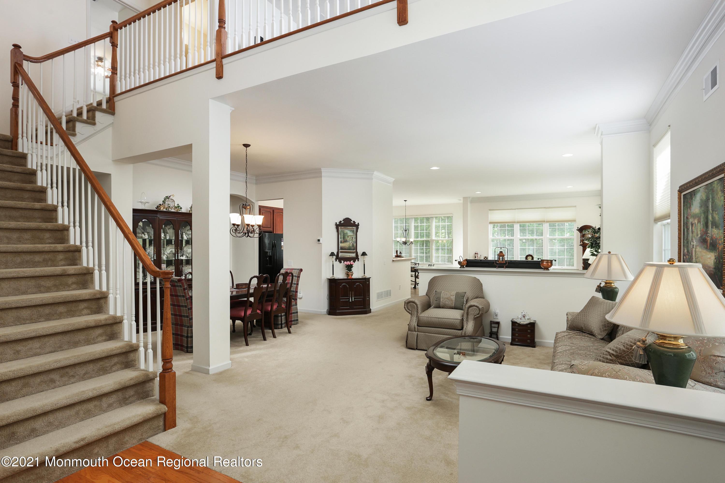 21 Crooked Stick Road Jackson, NJ 08527 - Photo 4 of 37 a living room with furniture and a chandelier