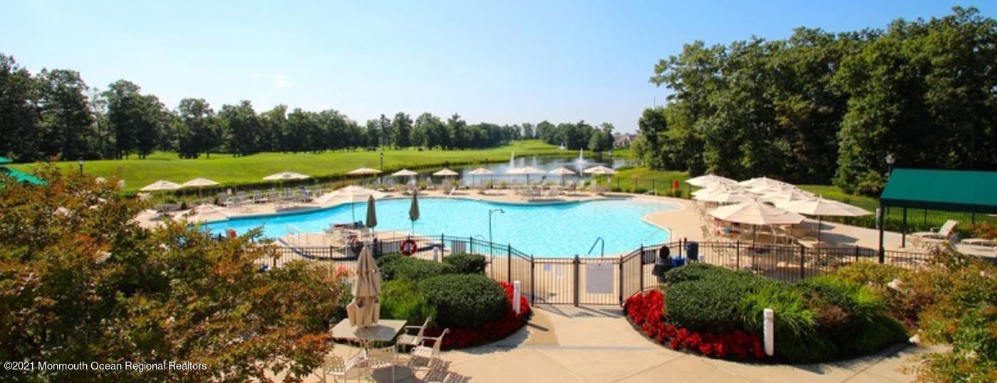 21 Crooked Stick Road Jackson, NJ 08527 - Photo 35 of 37 a view of a swimming pool with lawn chairs and a fire pit