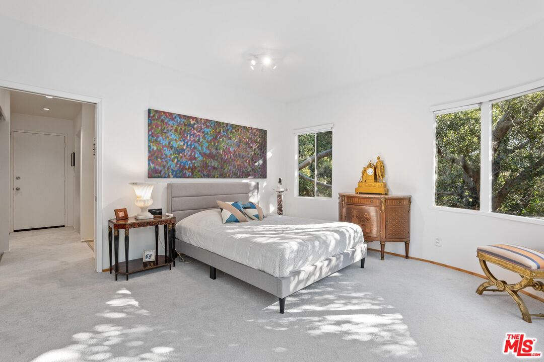 10045 Reevesbury Drive Beverly Hills, CA 90210 - Photo 14 of 32 a spacious bedroom with a bed and a large window