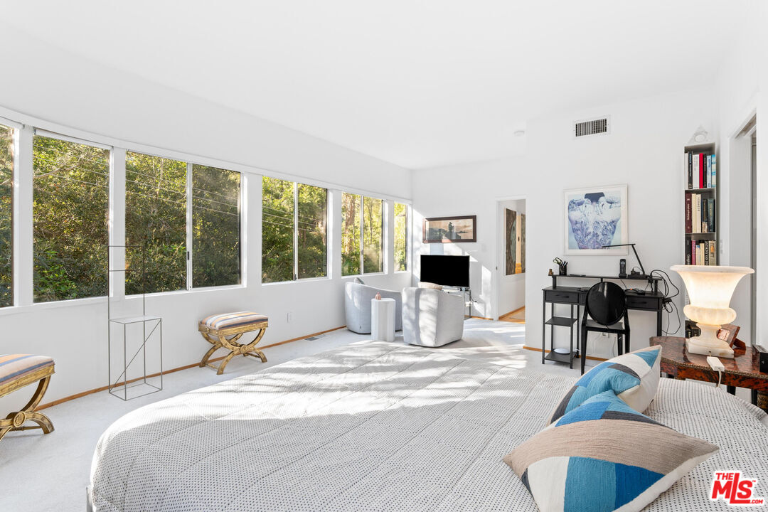 10045 Reevesbury Drive Beverly Hills, CA 90210 - Photo 15 of 32 a bedroom with furniture and a large window
