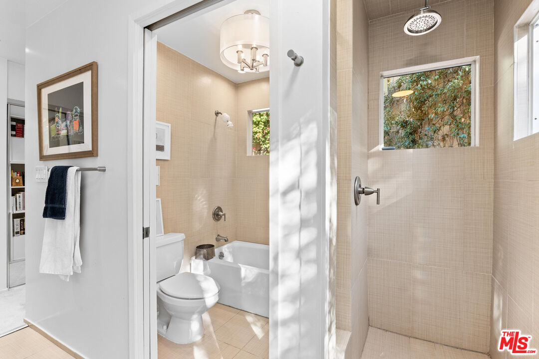 10045 Reevesbury Drive Beverly Hills, CA 90210 - Photo 19 of 32 a bathroom with a toilet sink and shower curtain