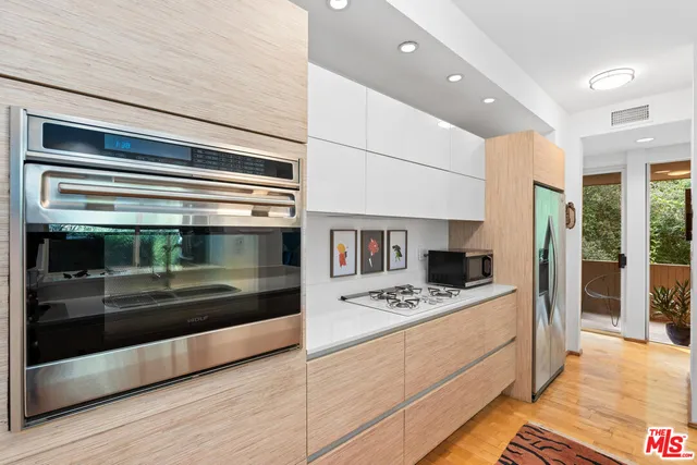 a kitchen with stainless steel appliances a stove and a refrigerator