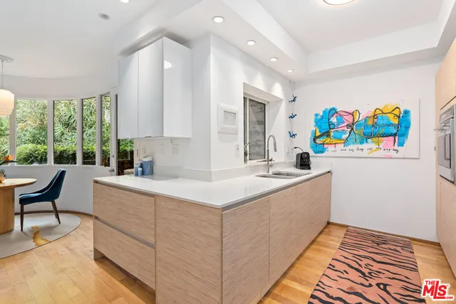 a kitchen that has a sink and a stove in it
