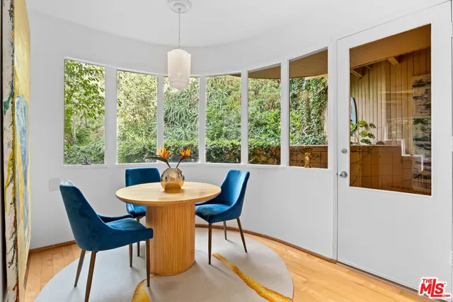 a dining room with furniture a chandelier and wooden floor