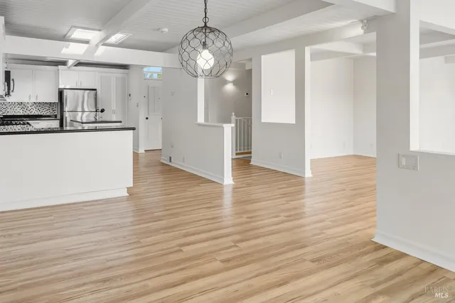 wooden floor chandelier and windows in a room