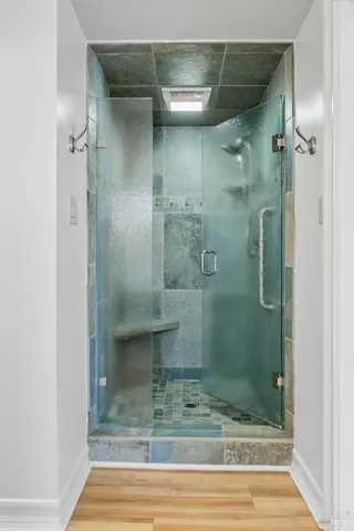 a view of an empty room with wooden floor