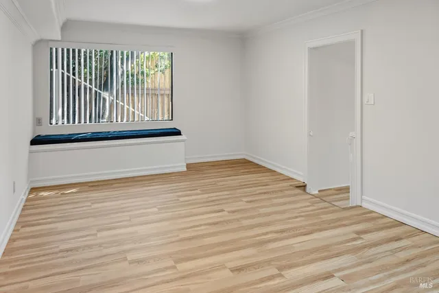 a view of a kitchen with white cabinets