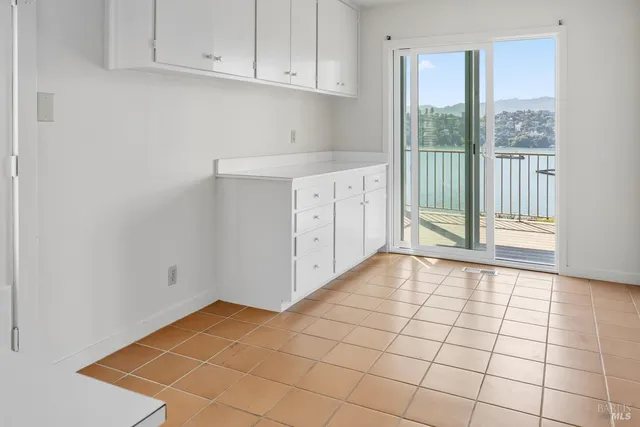 a view of an empty room and wooden floor