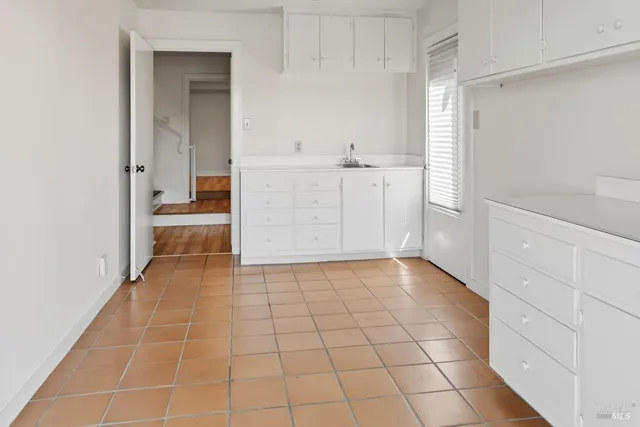 a view of a room with wooden floor and white walls