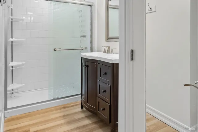 a view of a room with wooden floor and bench