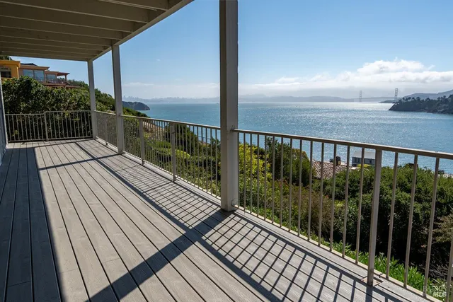 a kitchen with stainless steel appliances granite countertop a stove top oven a sink dishwasher and a refrigerator with wooden floor