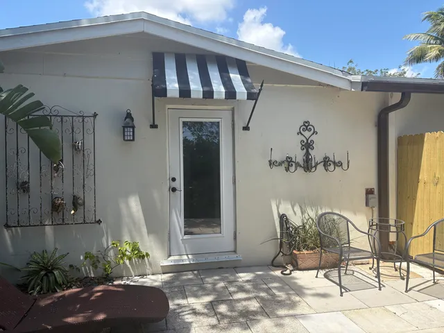 a view of a porch with furniture and floor to ceiling window