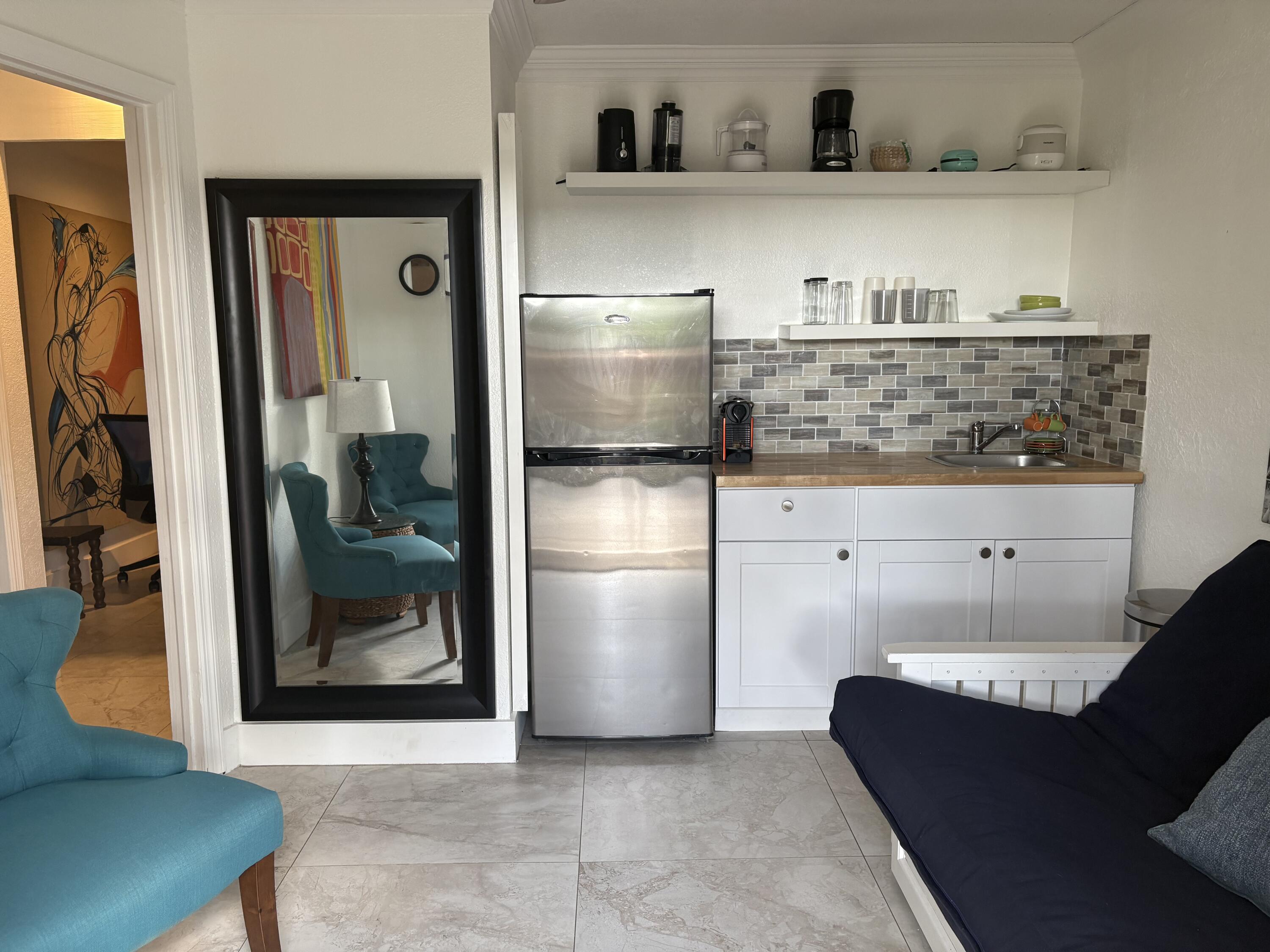 2565 Meadow Road West Palm Beach, FL 33406 - Photo 2 of 5 a kitchen with stainless steel appliances granite countertop a refrigerator and a sink
