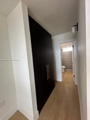 a view of hallway with wooden floor