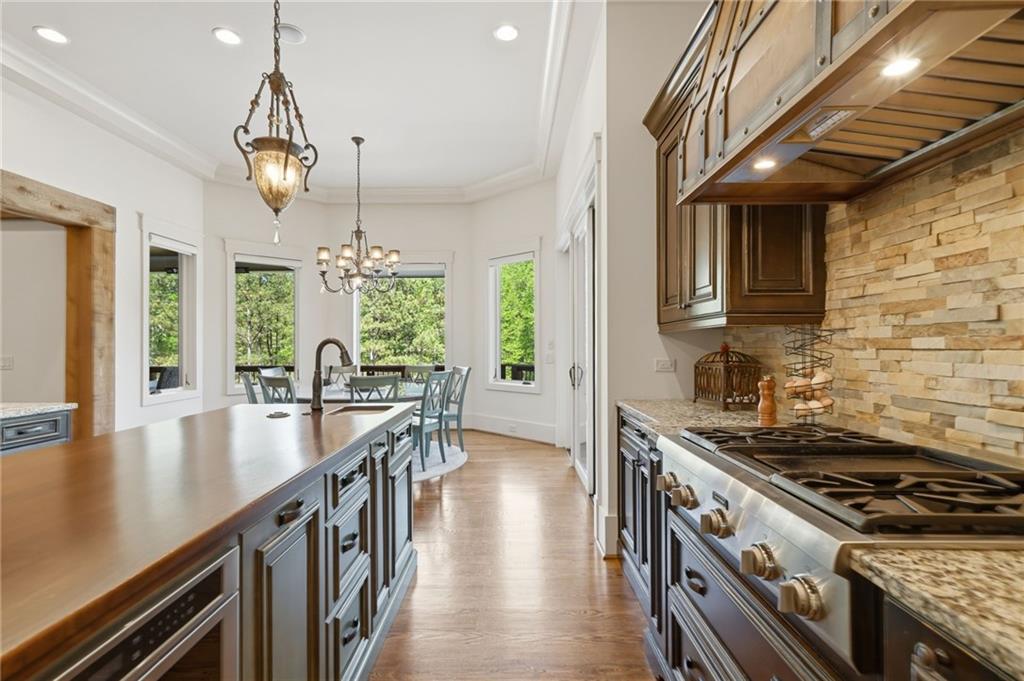 680 Gaddis Road Canton, GA 30115 - Photo 18 of 85 a kitchen with stove and wooden floor