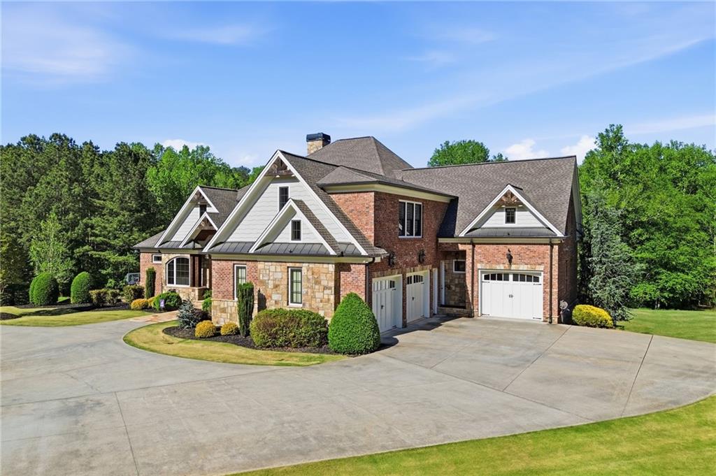 680 Gaddis Road Canton, GA 30115 - Photo 2 of 85 a front view of a house with a garden and trees