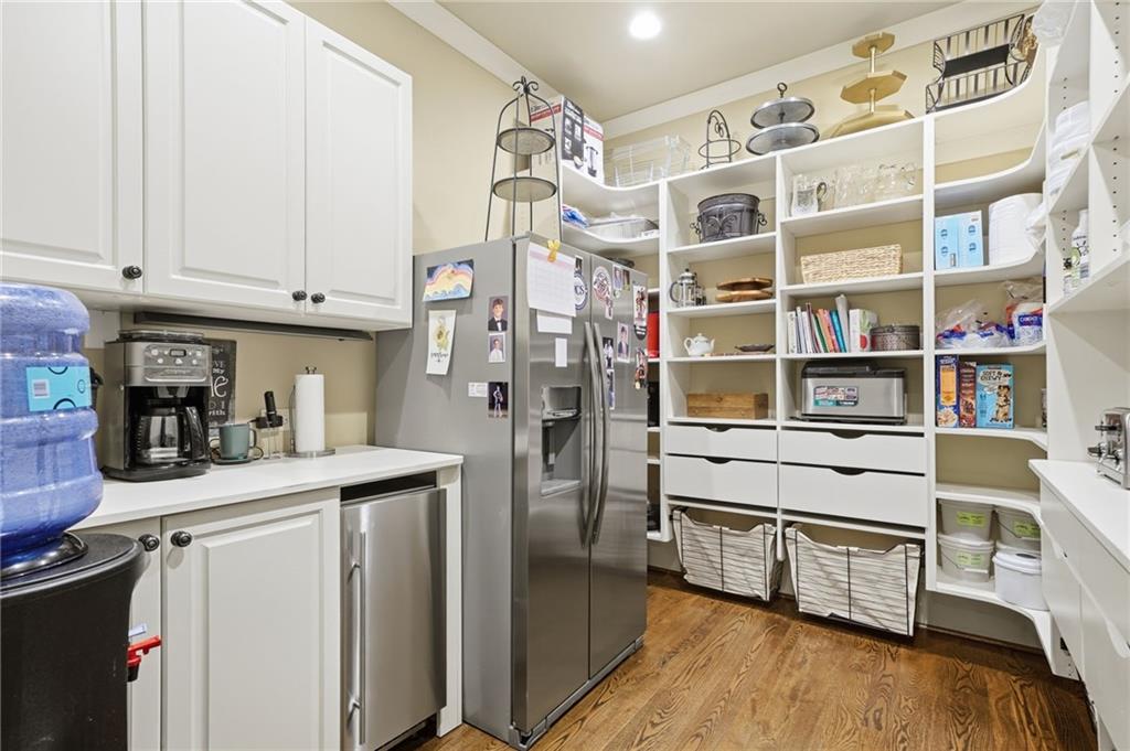 680 Gaddis Road Canton, GA 30115 - Photo 21 of 85 a kitchen with stainless steel appliances cabinets and a wooden floor