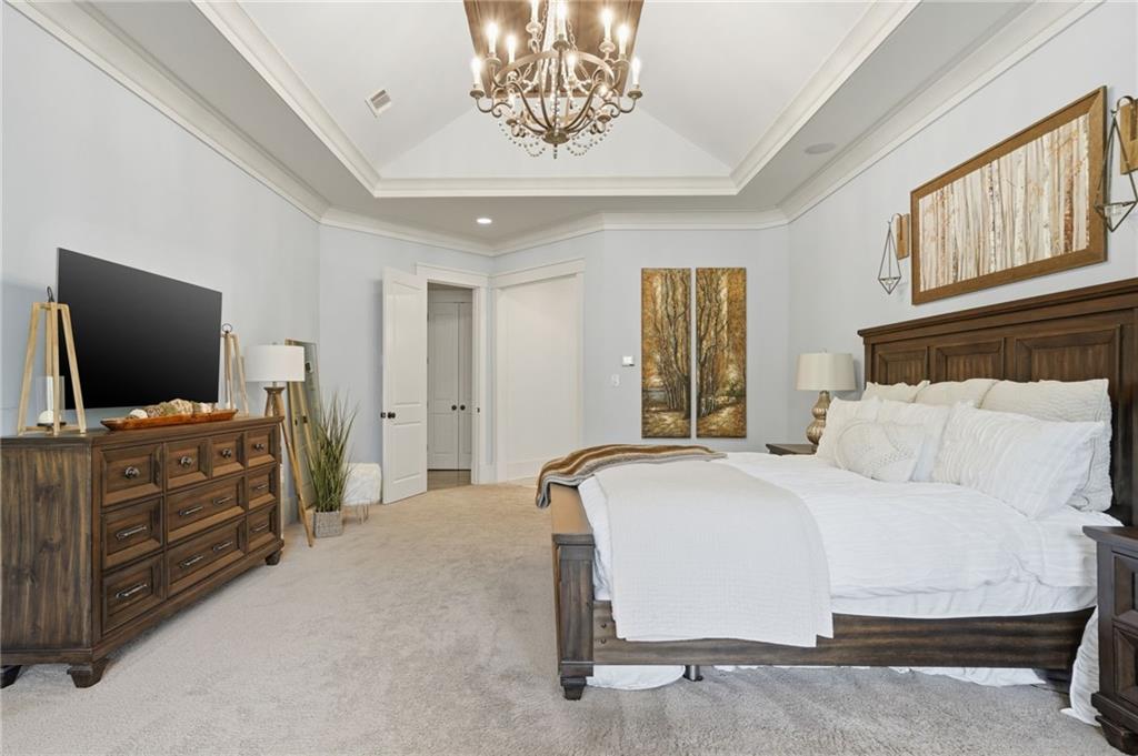 680 Gaddis Road Canton, GA 30115 - Photo 26 of 85 a bedroom with a bed and flat screen tv