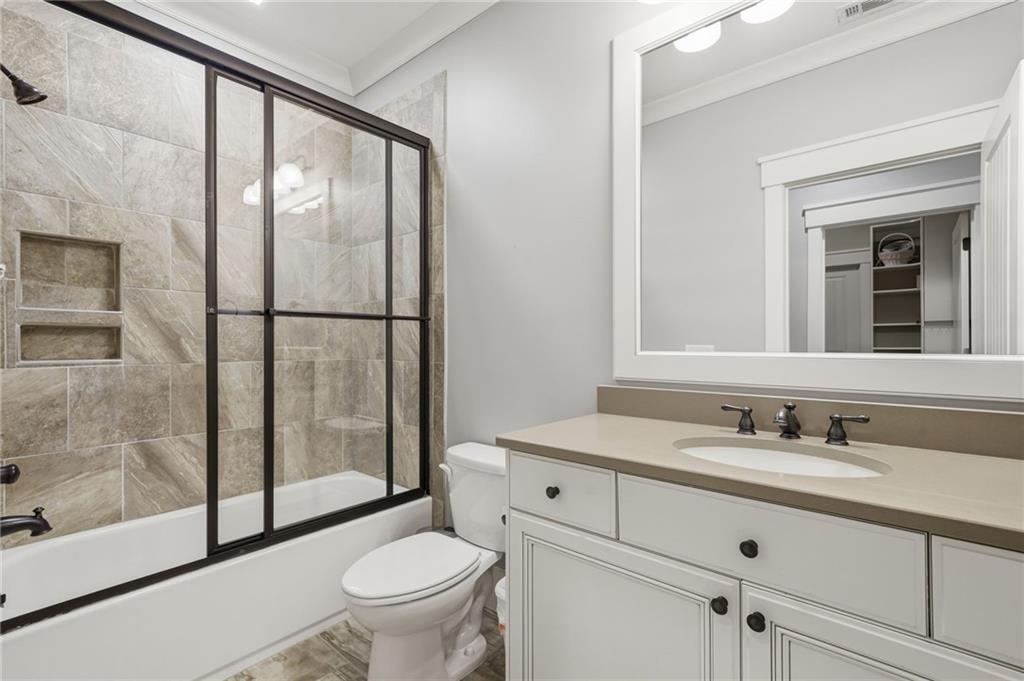 680 Gaddis Road Canton, GA 30115 - Photo 41 of 85 a bathroom with a sink a toilet and a large mirror